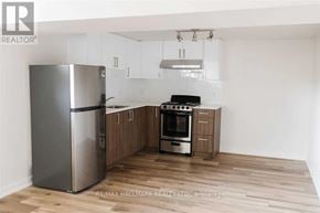 Toronto (Downsview-Roding-Cfb) apartment for rent - A kitchen with a refrigerator, oven, and cabinets.