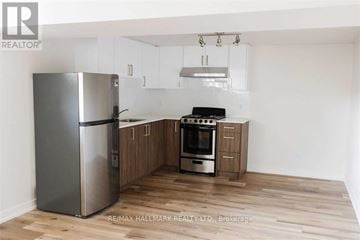 Toronto (Downsview-Roding-Cfb) apartment for rent - A kitchen with a refrigerator, oven, and cabinets.