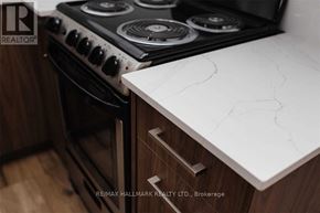 Toronto (Downsview-Roding-Cfb) apartment for rent - A modern kitchen with a white countertop and a black stove.