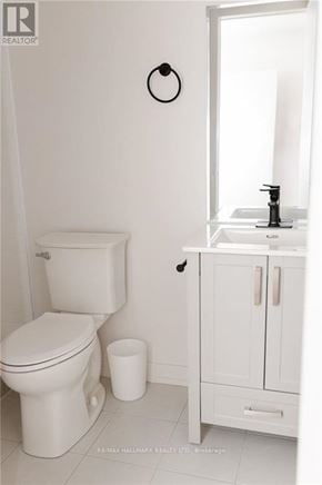 Toronto (Downsview-Roding-Cfb) apartment for rent - A white toilet sits next to a white sink in a bathroom.
