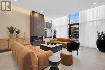 Ottawa condo for rent - A living room with a long sofa and a coffee table.