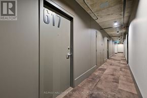 Ottawa condo for rent - A hallway with a door numbered 617 and a brokerage sign.