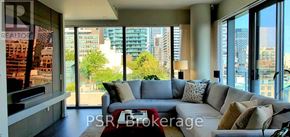 Toronto (Church-Yonge Corridor) condo for rent - A living room with a grey couch and a red coffee table.