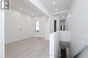 Toronto (South Riverdale) apartment for rent - A spacious room with a staircase leading to the upper floor.