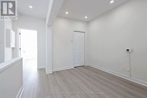 Toronto (South Riverdale) apartment for rent - A room with a white door and a window with sunlight coming in.