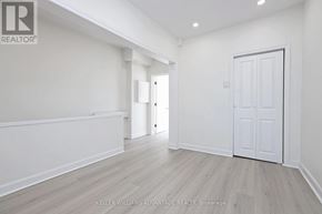 Toronto (South Riverdale) apartment for rent - A spacious room with a white door and a window.
