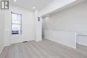 Toronto (South Riverdale) apartment for rent - A room with a window and a wall with a white panel.