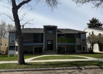 Edmonton apartment for rent - A modern house with a tree in front.