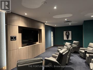 Hamilton (Corktown) condo for rent - A living room with a row of chairs and a flat screen TV.