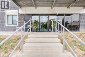Kitchener condo for rent - A set of stairs leads to a glass door entrance.
