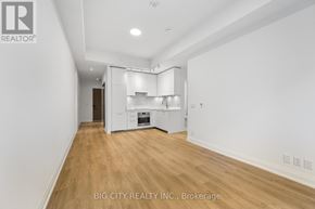 Toronto (Thorncliffe Park) condo for rent - A spacious room with a kitchen area in the background.