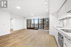 Toronto (Thorncliffe Park) condo for rent - A spacious kitchen with white cabinets and a large window.