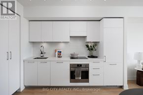 Toronto (Thorncliffe Park) condo for rent - A white kitchen with a sink, stove, and cabinets.