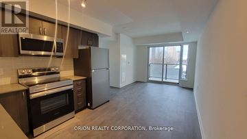 Toronto (Yorkdale-Glen Park) condo for rent - A kitchen with a stove top oven and a microwave above it.