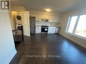 Toronto (Rustic) apartment for rent - A kitchen with white cabinets and a black stove top oven.