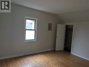 Windsor duplex for rent - A room with a window and a closet.