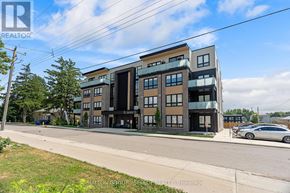 South Huron (Exeter) multi-family for rent - A modern multi-story apartment building with a car parked in front.