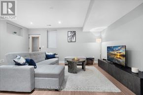 Toronto (Oakridge) apartment for rent - A living room with grey couches and a flat screen TV.