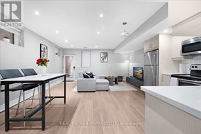 Toronto (Oakridge) apartment for rent - A modern kitchen and living room with a dining table and chairs.