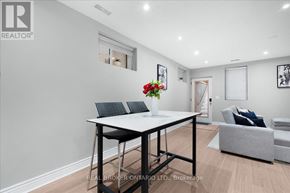 Toronto (Oakridge) apartment for rent - A real estate office with a table and chairs in the foreground.
