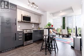 Toronto (Birchcliffe-Cliffside) condo for rent - A modern kitchen with a refrigerator, stove, and bar stools.