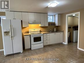 Barrie (Innis-Shore) apartment for rent - A kitchen with white appliances and cabinets.