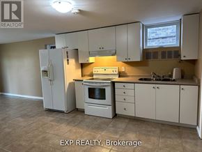 Barrie (Innis-Shore) apartment for rent - A kitchen with white appliances and cabinets.