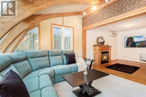 Oakville (Br Bronte) apartment for rent - A living room with a blue couch and a fireplace.