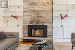 Oakville (Br Bronte) apartment for rent - A living room with a fireplace and a grey couch.