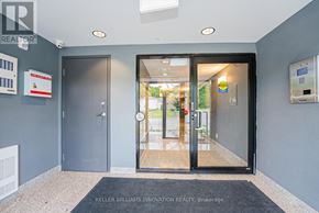 Kitchener condo for rent - The image shows the front entrance of a building with a glass door and a sign that reads "KELLER WILLIAMS INNOVATION REALTY Brokerage".