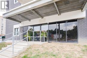 Kitchener condo for rent - A modern house with a glass door and a covered patio area.
