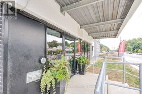 Kitchener condo for rent - A balcony with a metal railing and a glass door.
