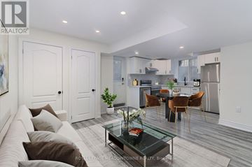 Milton (Fo Ford) apartment for rent - A modern living room with a glass coffee table and a dining area in the background.