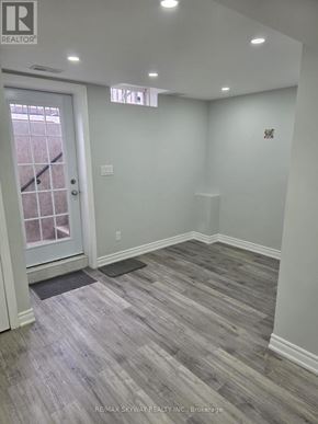 Brampton (Northwest Brampton) apartment for rent - A room with a wooden floor and a white door.