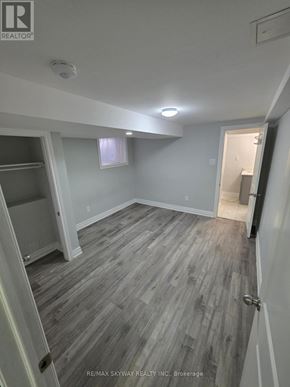 Brampton (Northwest Brampton) apartment for rent - A room with grey wooden flooring and white walls.