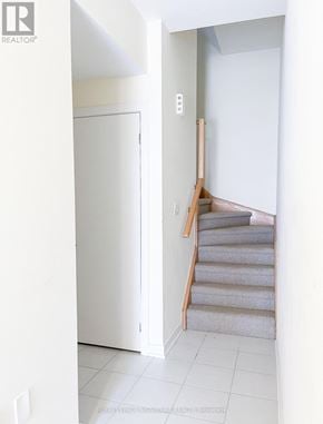 Hamilton (Lakeshore) townhouse for rent - A staircase with a white door and a white wall.