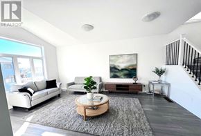 Kingston (City Northwest) apartment for rent - A living room with a white couch, a coffee table, and a painting on the wall.