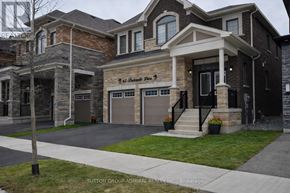 Whitby apartment for rent - A house with a sign that says "Sutton Group" in front of it.