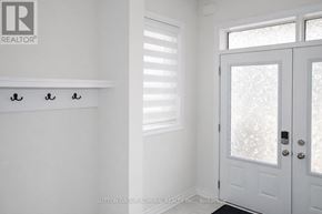 Whitby apartment for rent - A white door with a glass window and a handle is in a room.