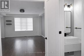 Whitby apartment for rent - A bathroom with a sink, mirror, and a window with blinds.