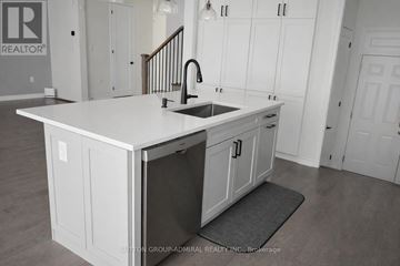 Whitby apartment for rent - A kitchen with white cabinets and a sink.