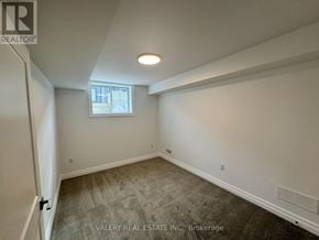 Niagara Falls (Brown) townhouse for rent - A room with a window and a door leading to another room.