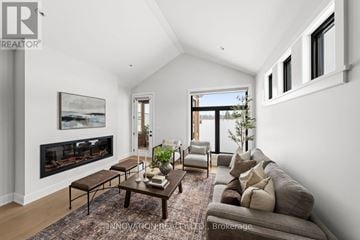 Ottawa townhouse for rent - A modern living room with a fireplace and a large painting on the wall.