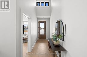 Ottawa townhouse for rent - A hallway with a wooden bench and a mirror on the wall.