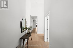 Ottawa townhouse for rent - A hallway with a bench and a mirror on the wall.