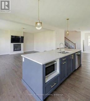 Ottawa apartment for rent - A modern kitchen with a large island and wooden floors.