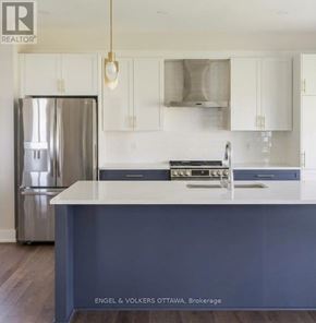 Ottawa apartment for rent - A kitchen with a stainless steel refrigerator and a sink with a countertop.