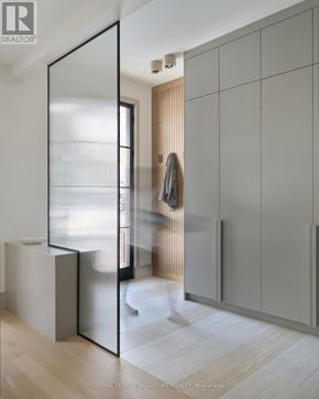 Toronto (Playter Estates-Danforth) apartment for rent - A modern room with a glass door and a coat hanging on the wall.