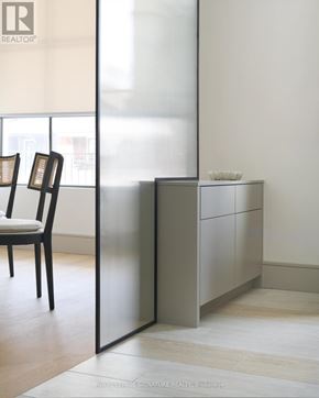 Toronto (Playter Estates-Danforth) apartment for rent - A modern room with a chair and a cabinet.