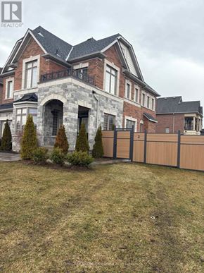 East Gwillimbury (Holland Landing) apartment for rent - A large house with a stone archway entrance and a fence.